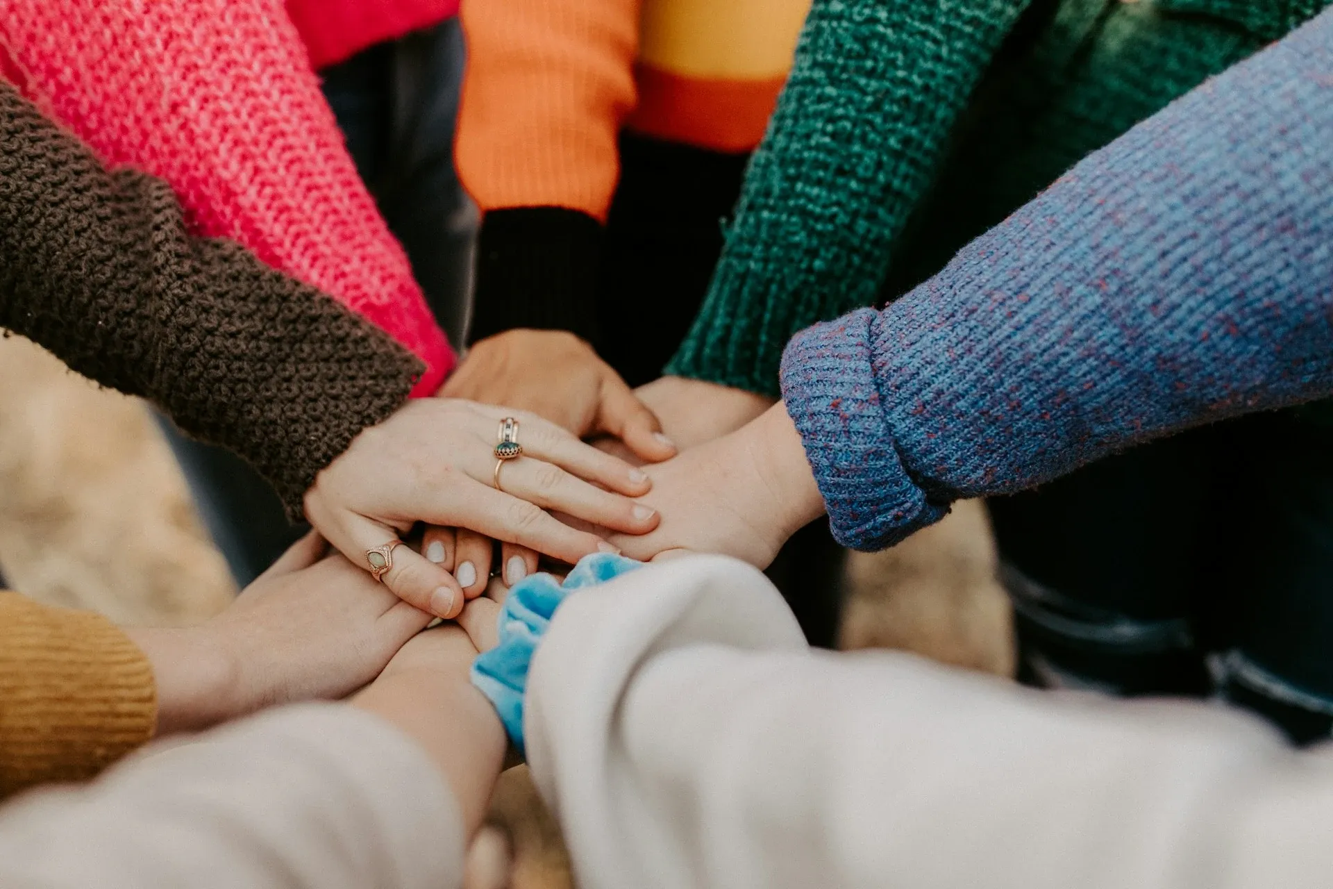 Photo of hands in a circle.
